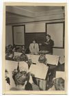 Herbert Carter monitoring student conductor 